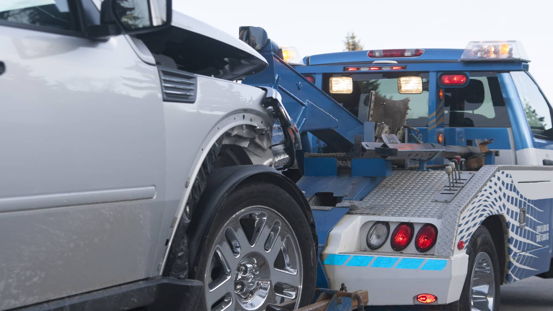Jeff's Towing recovering a vehicle at dusk