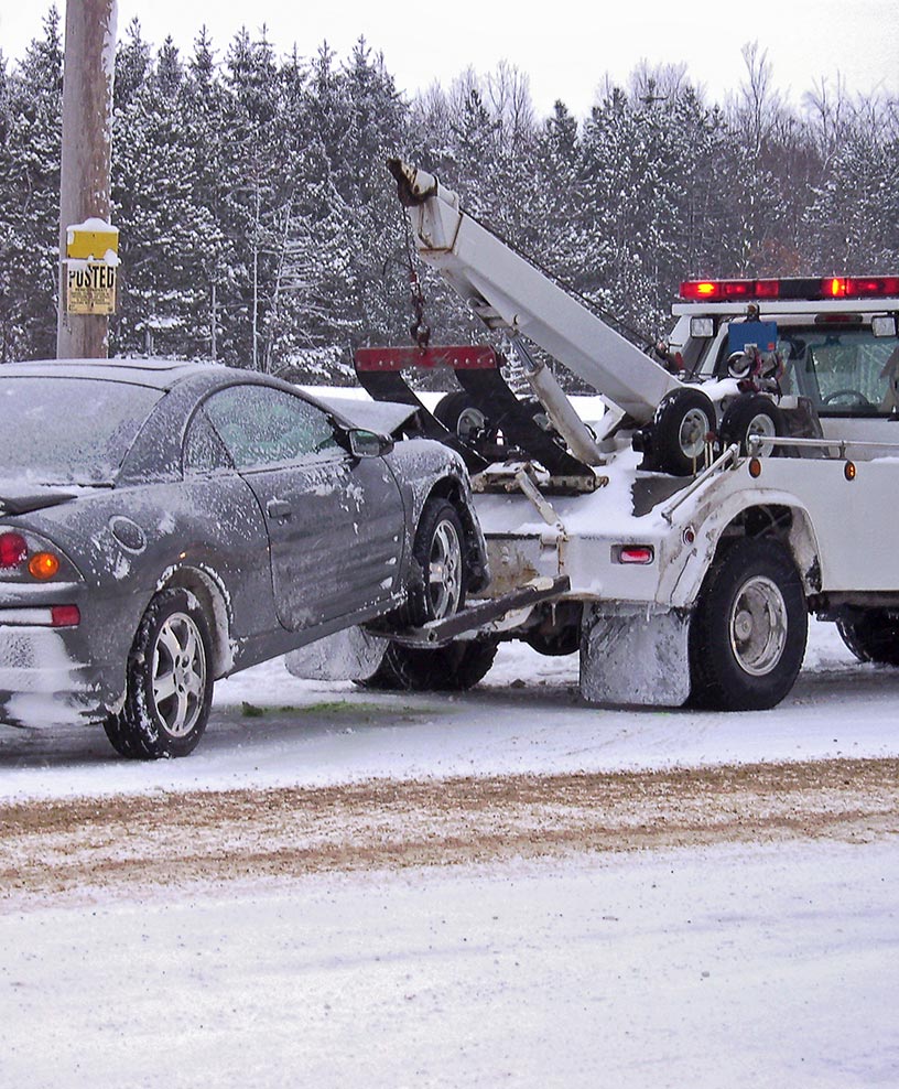 Jeff's Towing recovering a car in a Michigan snowstorm