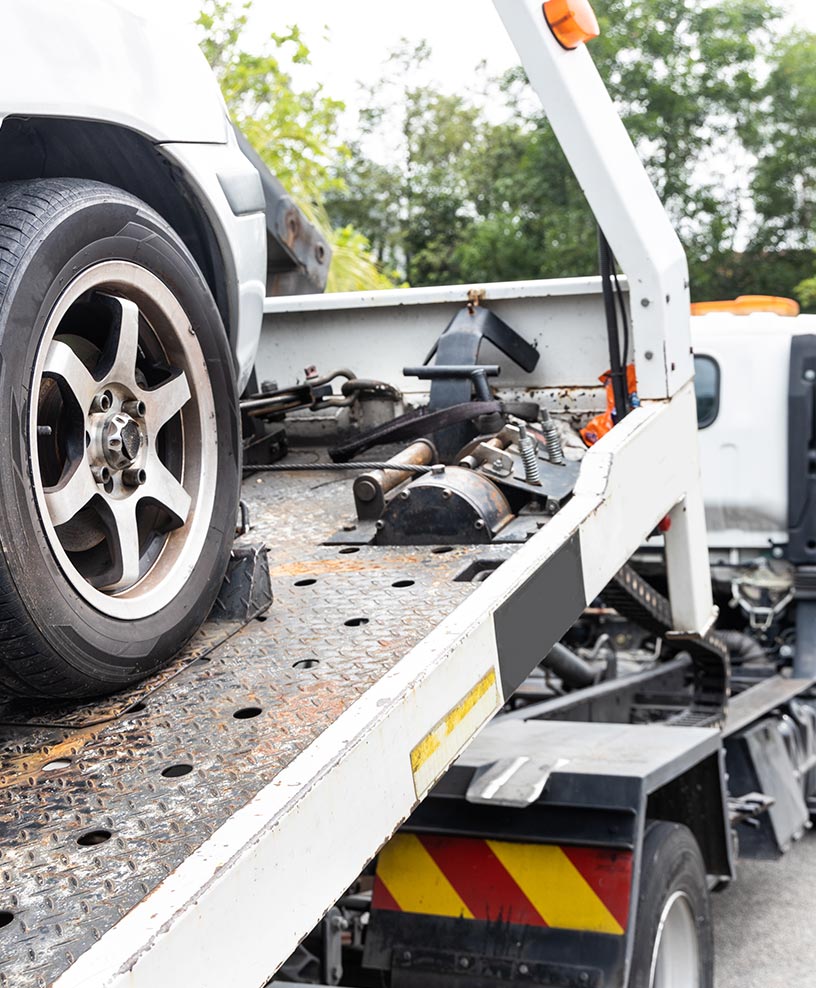 Car secured on a flatbed tow truck
