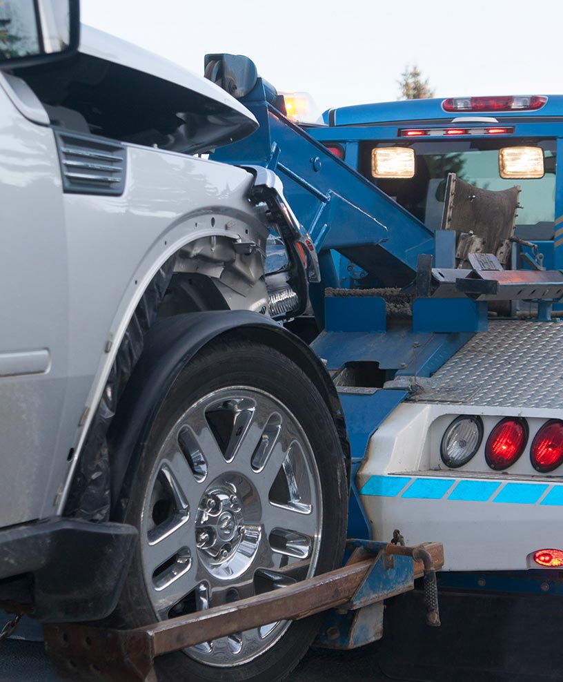 Tow truck loading a vehicle for transport